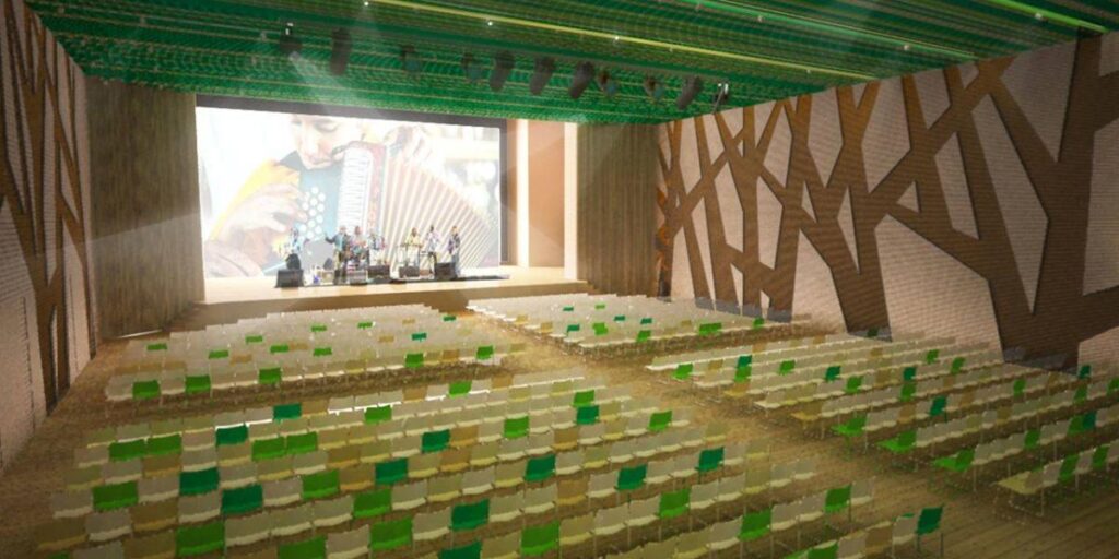 Maqueta digital del auditorio del Centro Cultural de la Música Vallenata con escenario, pantalla gigante y silletería en tonos verde y amarillo.