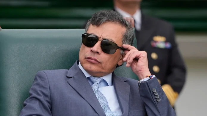 Gustavo Petro con gafas oscuras y expresión seria, reaccionando a la orden judicial que le prohíbe hablar de las elecciones en Colombia.