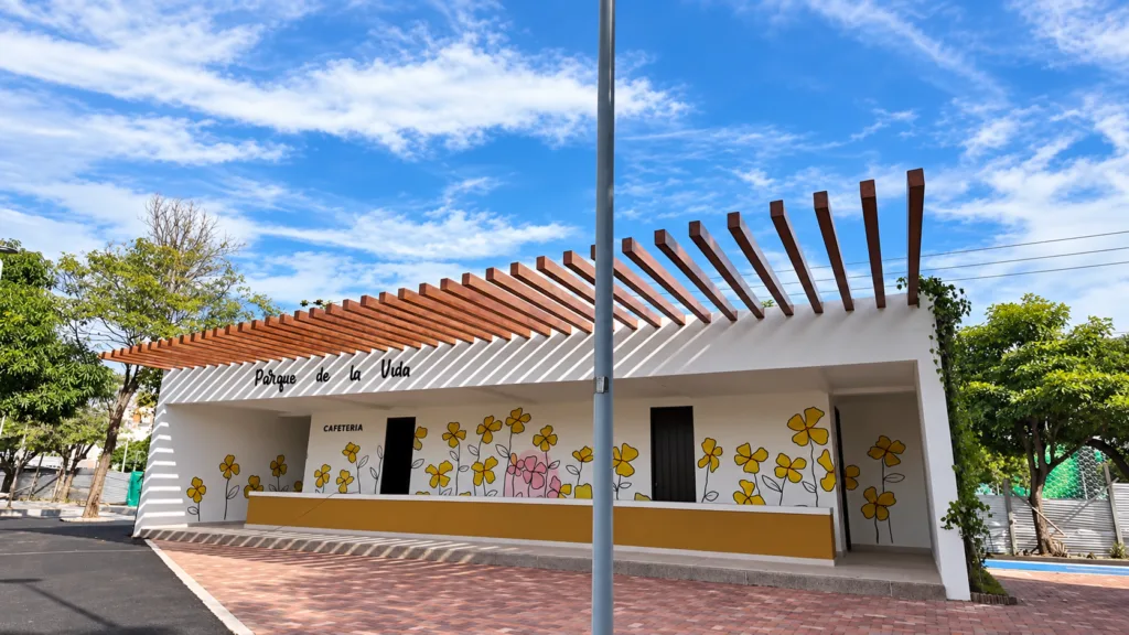 Fachada de la cafetería del Parque de la Vida en Valledupar, con pérgola y murales de flores.